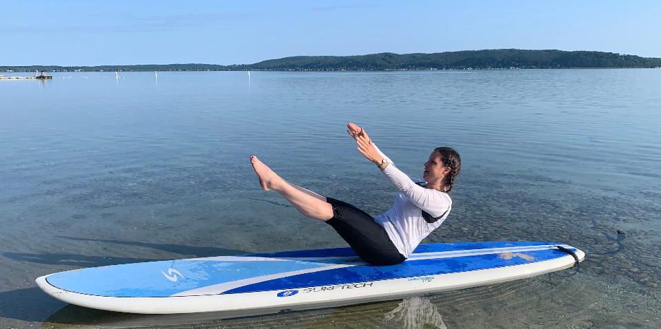 Tiffany demonstrating a Pilates pose outdoors